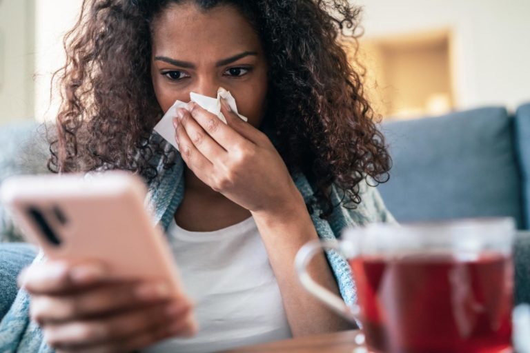 Woman blowing nose