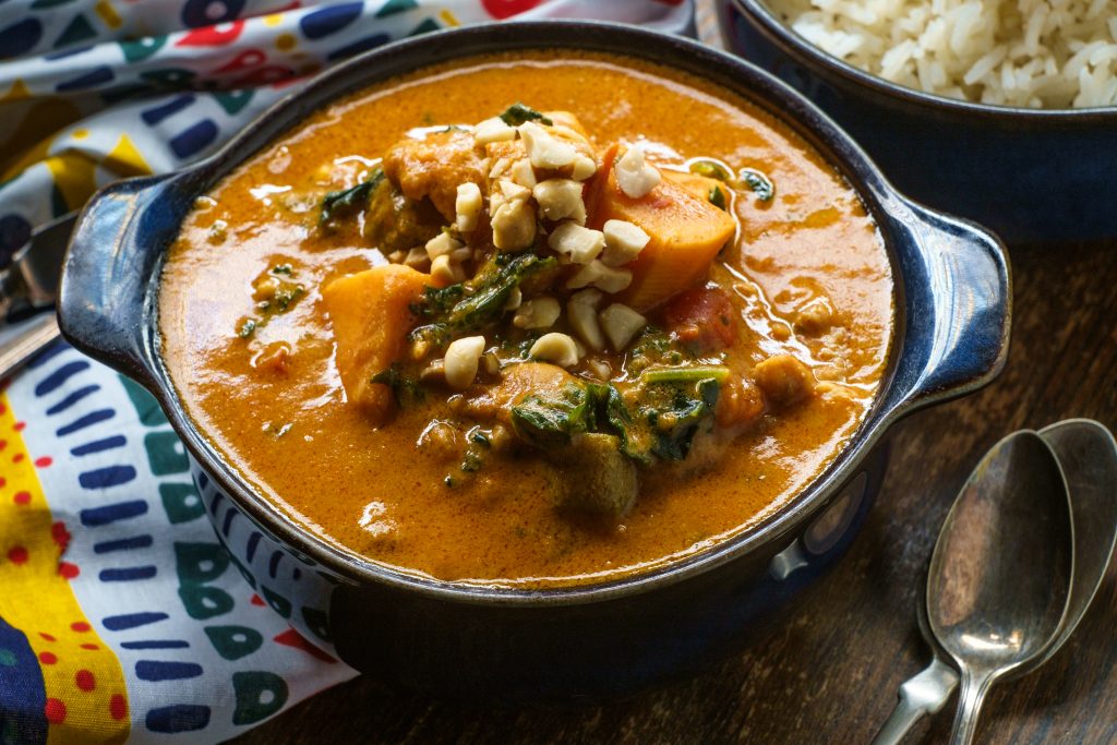 African chicken peanut stew with sweet potatoes and okra with side of basmati rice