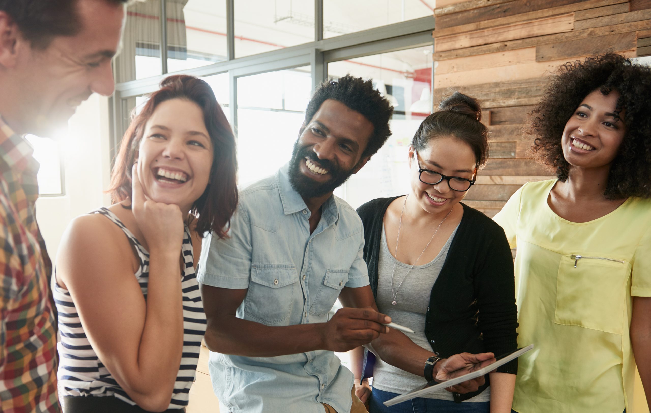 A group of adults apppear to be engaged in a conversation.